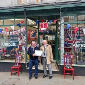 Coronation Best Dressed Window Competition - Winner - Gloucester Antiques Centre. Certificate accepted here by Denzil on behalf of the owners Min and Mick.